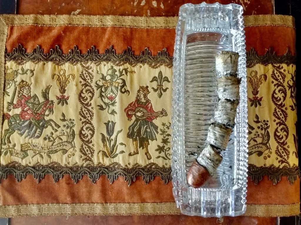 St. Gallen vintage handmade placemat, Princess House crystal ashtray, and complete ashes of a&nbsp;cigar