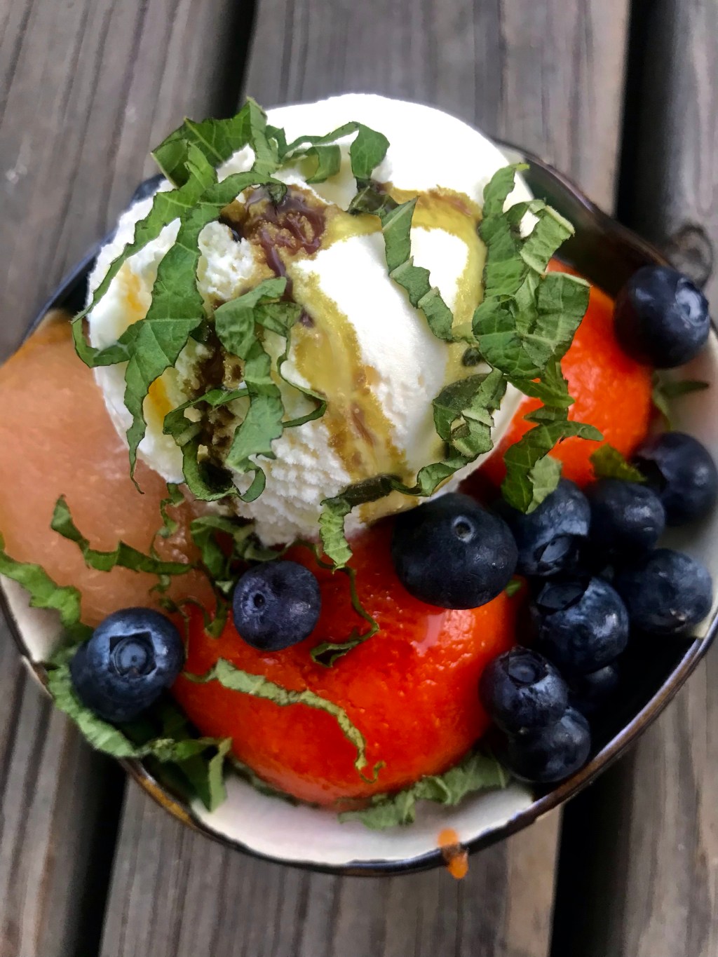 Shredded shiso, drunken pear, papaya, blueberries, vanilla ice cream, and pumpkin seed&nbsp;oil