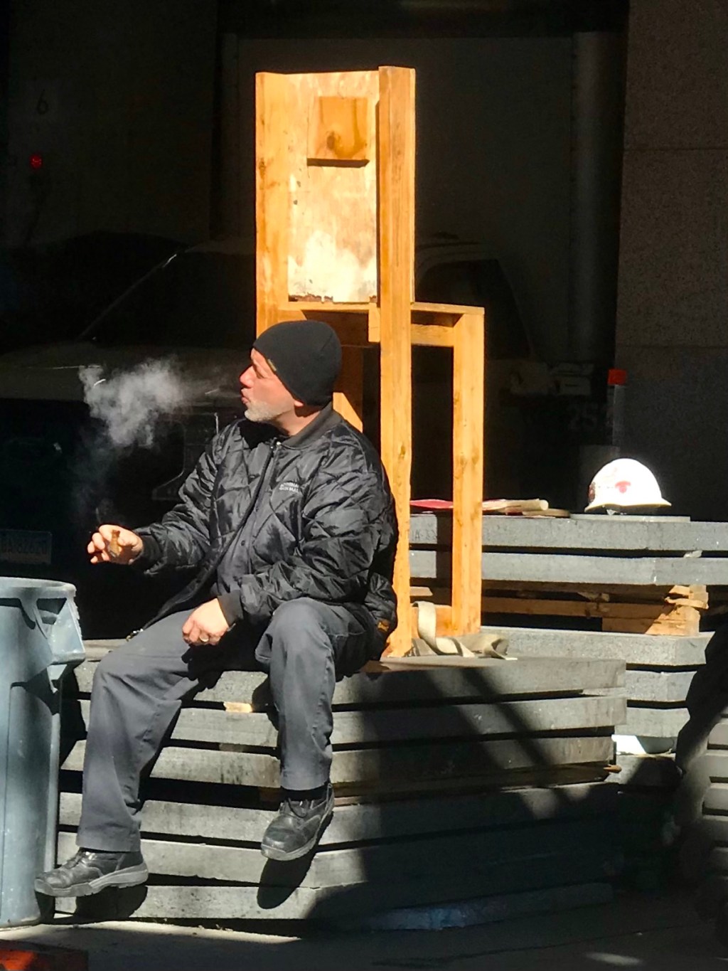 Worker behind chair, with&nbsp;cigar